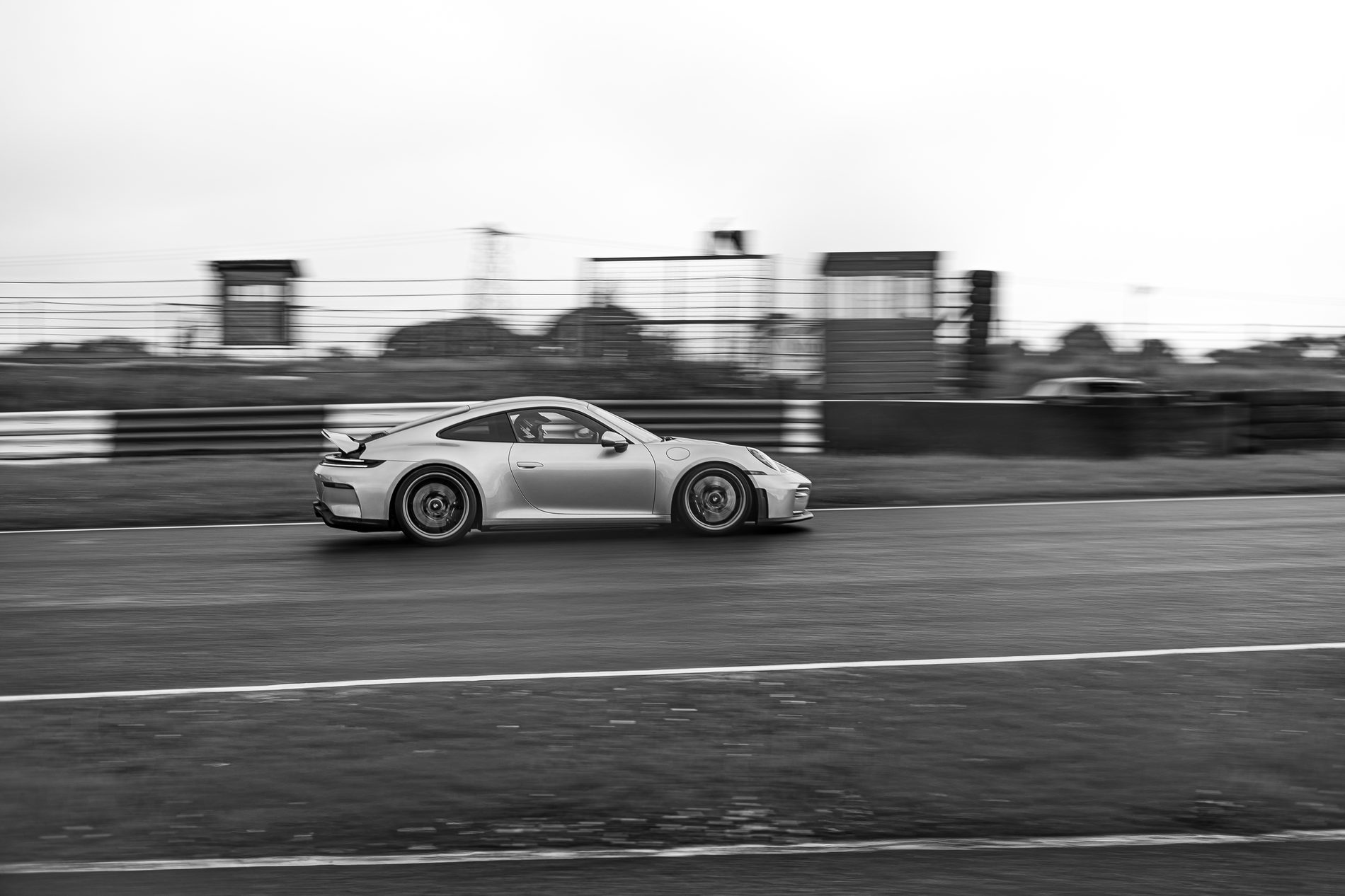 Silver Porsche 911 GT3 panning shot, black and white